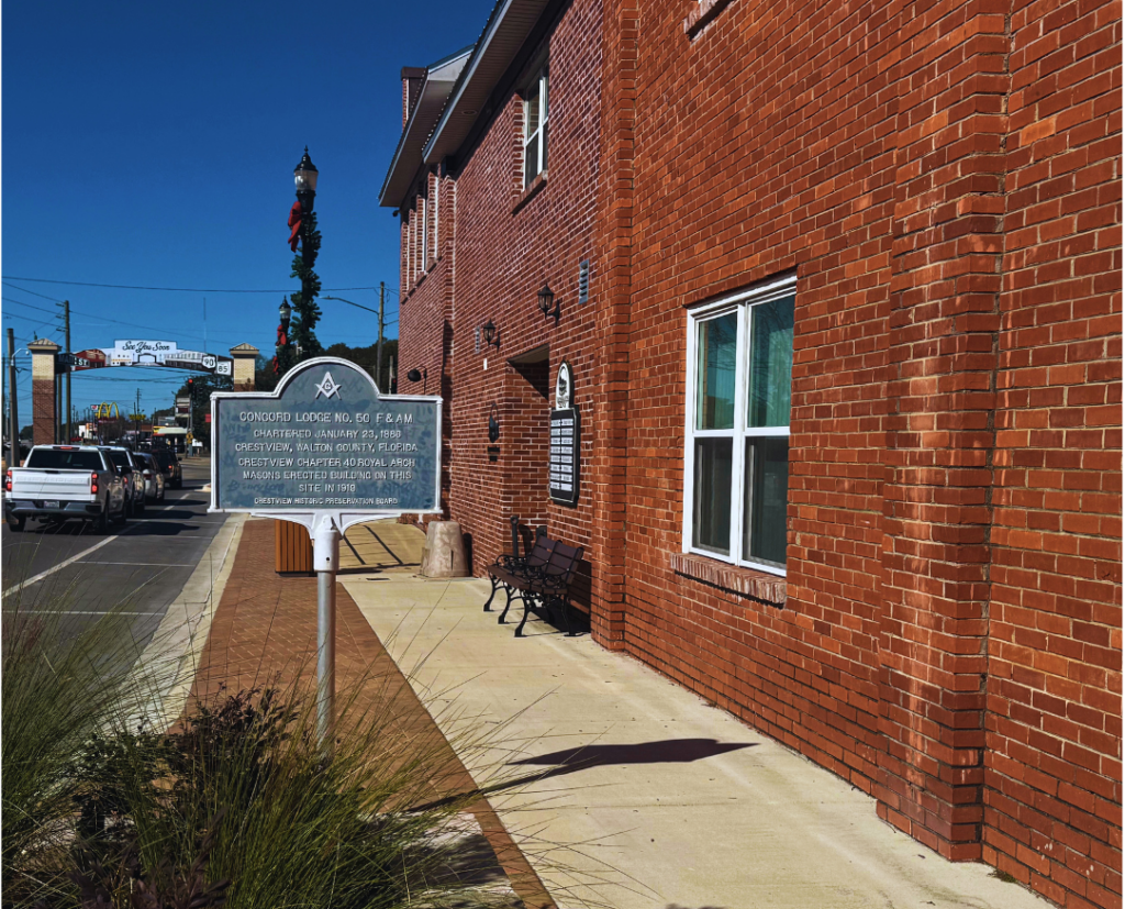 Sidewalk view of Courthouse Suites Crestview in downtown Crestview, Florida, highlighting its walkable location and historic brick office building